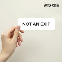 Load image into Gallery viewer, Bulk Case of 100 Sets - Not An Exit Sign, Durable ABS Plastic with Full Adhesive Backing, Sign for Door or Wall, 2x6" (White)