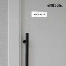 Load image into Gallery viewer, Bulk Case of 100 Sets - Not An Exit Sign, Durable ABS Plastic with Full Adhesive Backing, Sign for Door or Wall, 2x6" (White)