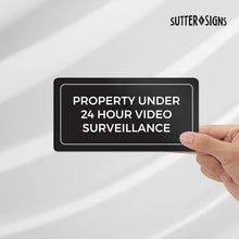 Load image into Gallery viewer, Bulk Case of 100 Signs - Property Under 24 Hour Video Surveillance Sign, 3x6" ABS Plastic Adhesive Security Camera Warning Plaque for Home &amp; Business