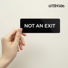 Load image into Gallery viewer, Bulk Case of 250 Signs - Not An Exit Sign, Durable ABS Plastic with Full Adhesive Backing, Sign for Door or Wall, 2x6&quot;