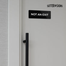 Load image into Gallery viewer, Bulk Case of 250 Signs - Not An Exit Sign, Durable ABS Plastic with Full Adhesive Backing, Sign for Door or Wall, 2x6"