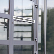Load image into Gallery viewer, Bulk Case of 150 Signs - This Door to Remain Unlocked During Business Hours Sign | 1" High Text Adhesive Decal White Sticker 2x26 inches