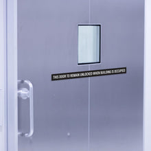 Load image into Gallery viewer, Bulk Case of 150 Sets - This Door To Remain Unlocked When Building Is Occupied Sign Adhesive Decal Sticker 2x26 inches (Pack of 2)