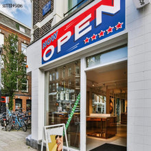 Load image into Gallery viewer, Bulk Case of 100 Signs - Now Open Banner, 3' x 8' Open Sign for Businesses, Shops, Polyester Banner with Grommets, Rope Included for Easy Installation